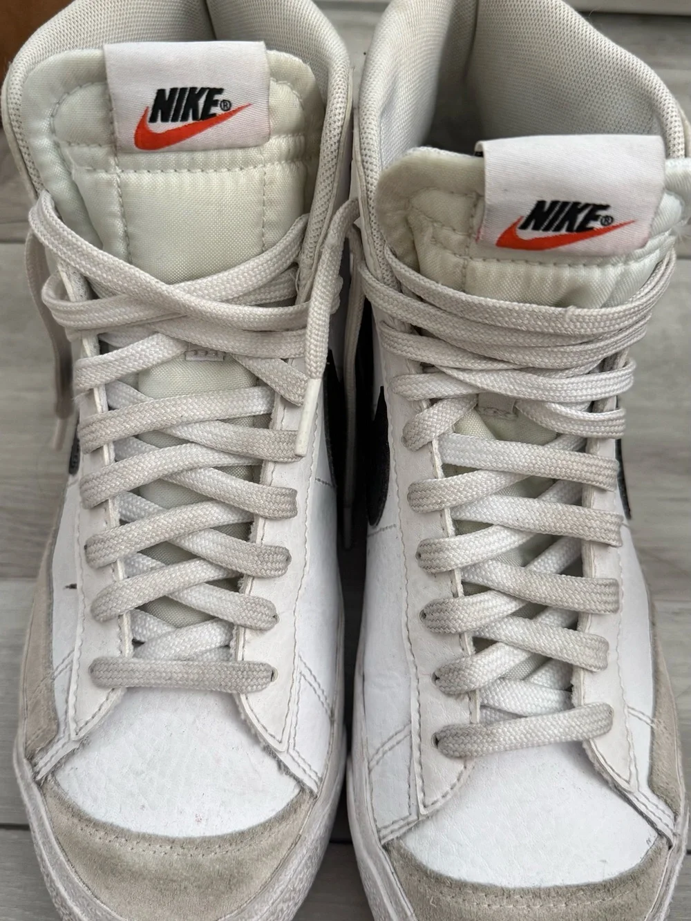Nike White High-Top Sneakers with Black Swoosh and Orange Tongue Logo